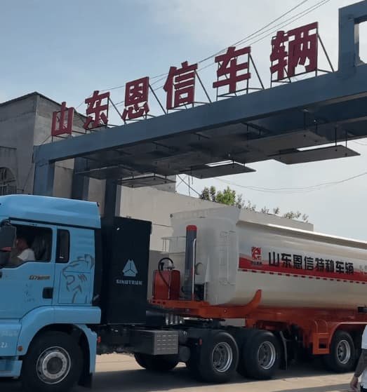 Enxin 3 axle rear dump semi trailer departing factory gates for delivery