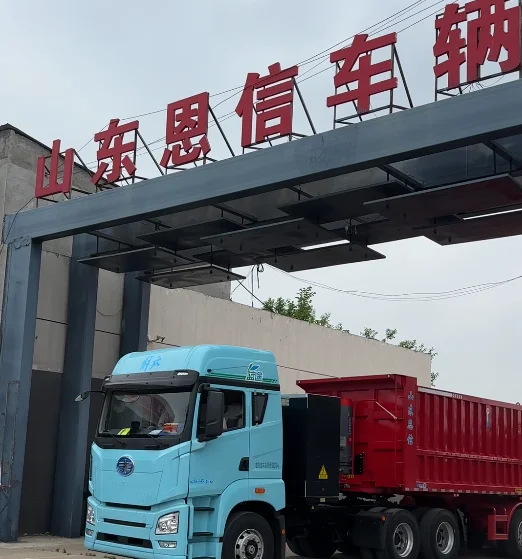 A fleet of Enxin 3 axle rear dump tipper trailers departing the factory gate for port delivery