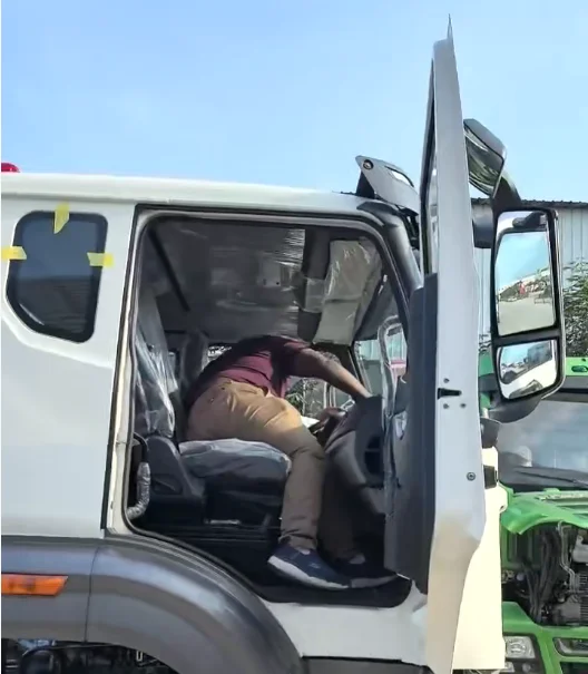 Cameroonian client test driving a heavy duty tractor truck cab at Enxin factory
